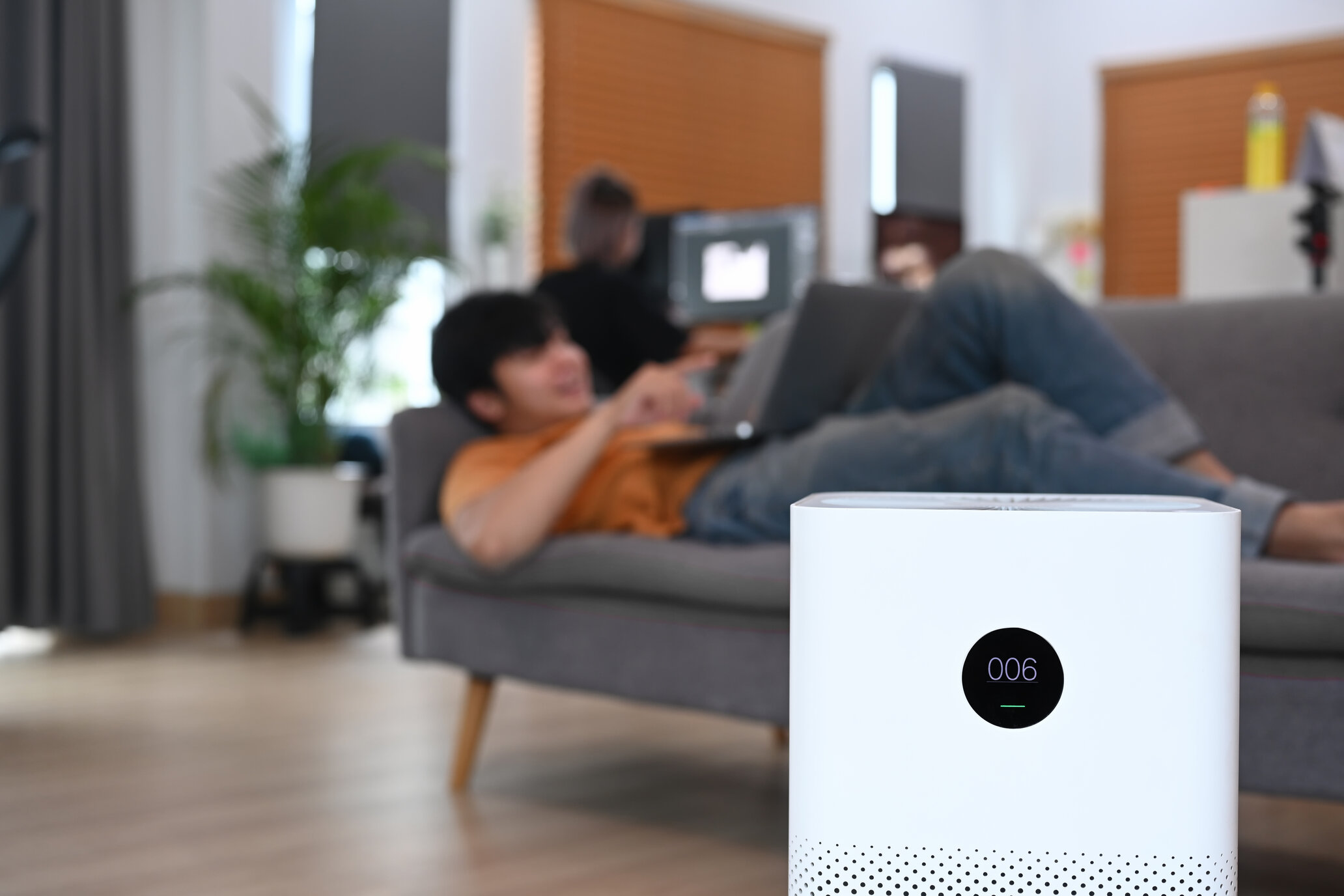 person lying on couch with portable ac